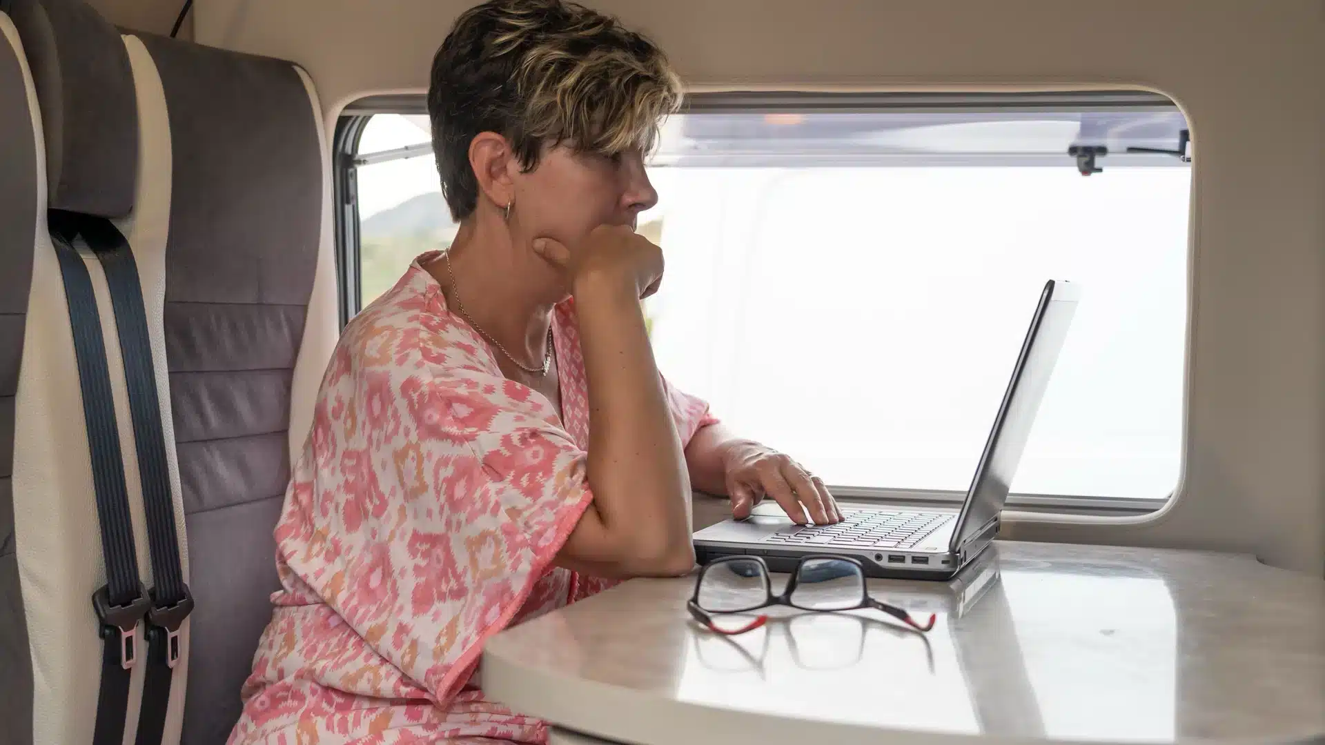 lady in caravan on laptop